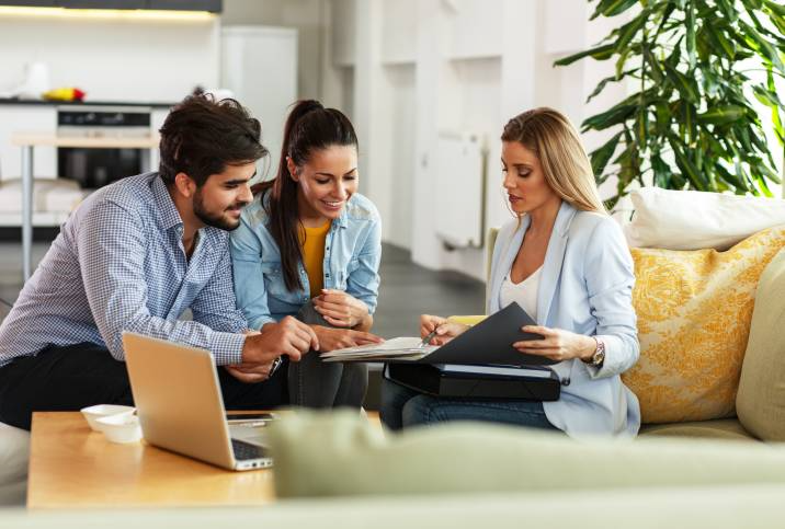 real estate agent assisting her clients