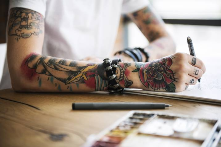 artist sketching out tattoo designs