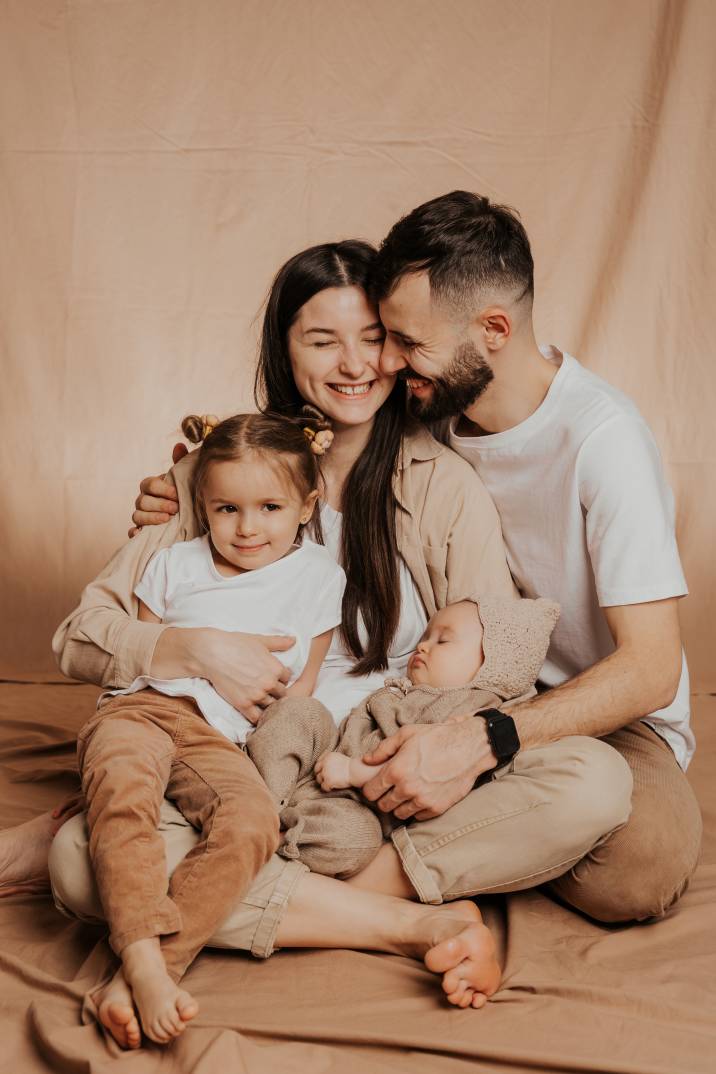 a portrait of a smiling couple and their two children