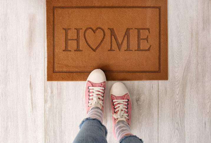 feet near door mat for keeping dirt and dust out