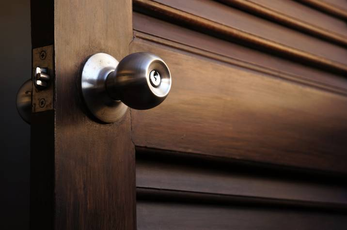 keyed door knob on a wooden door