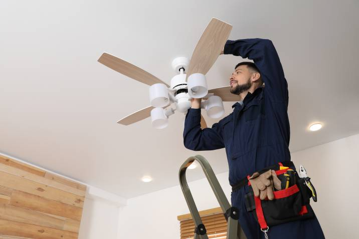 handyman installing a ceiling fan