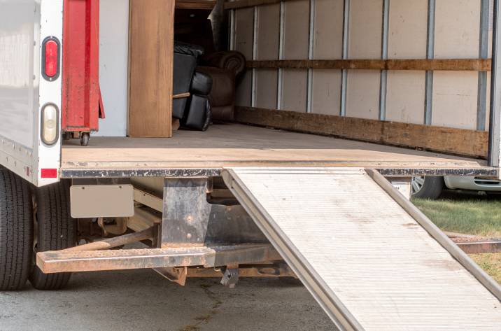 ramp on moving van partially loaded with furniture