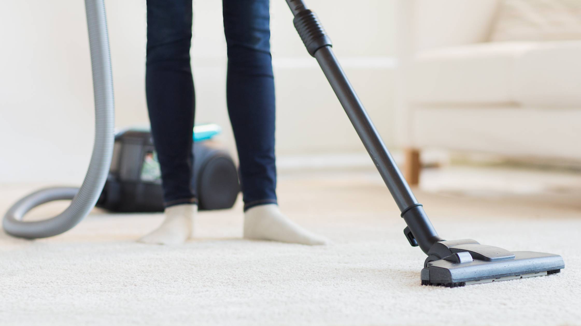 a woman vacuuming a carpet