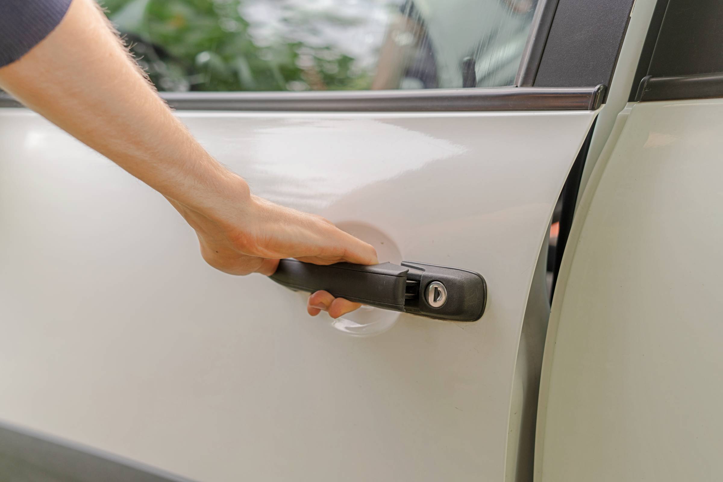 a person holding an unlocked car door