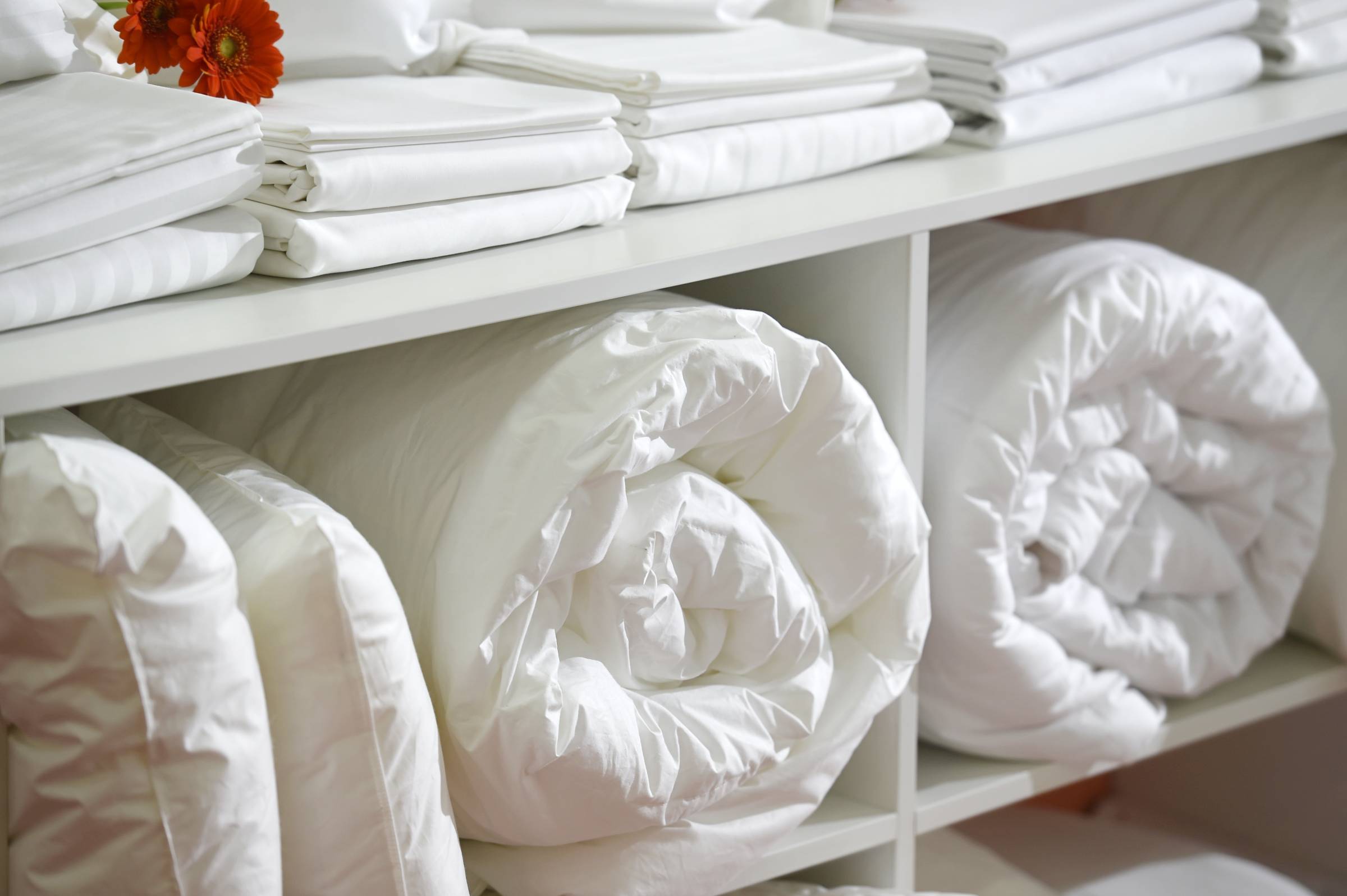 pillows and duvets in a cabinet