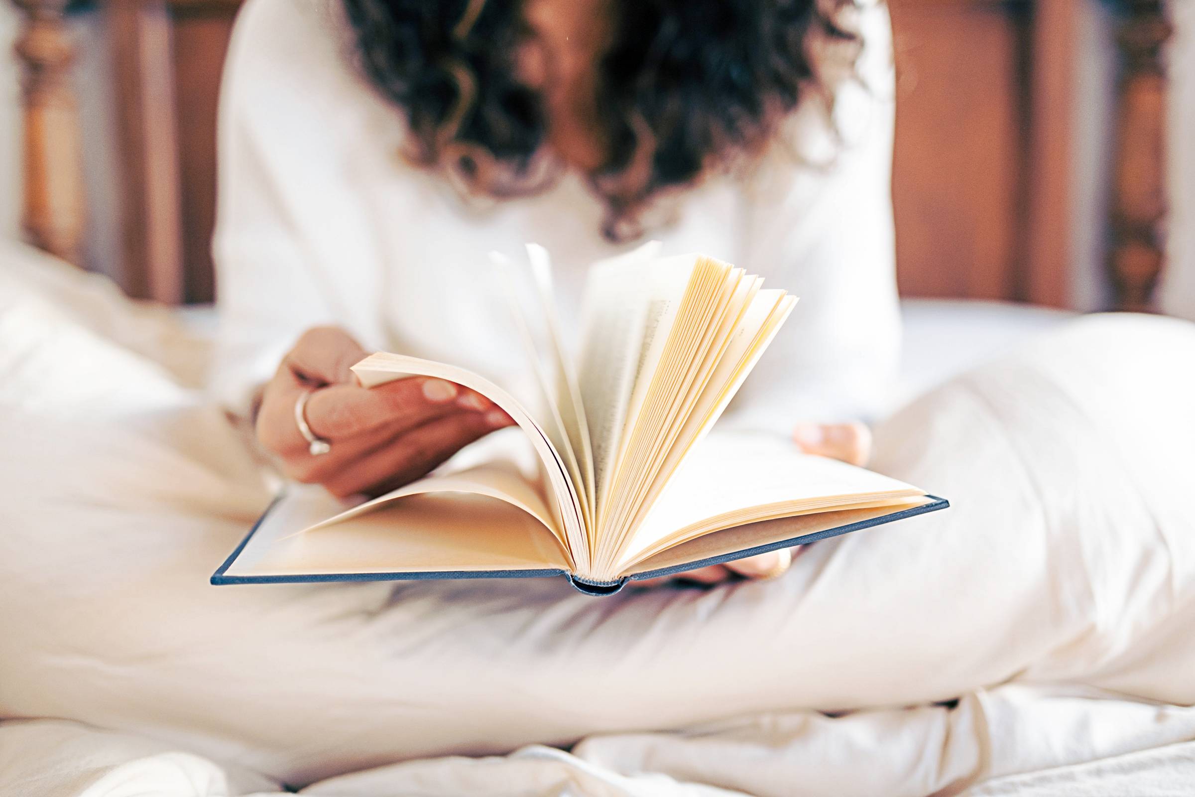 a woman reading in her bedroom