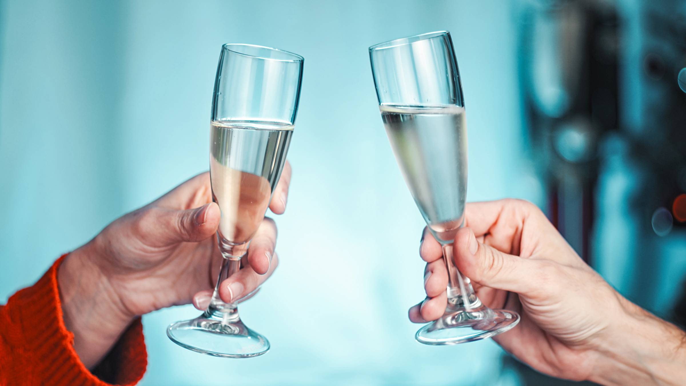 A couple toasting champagne goblets for the New Year