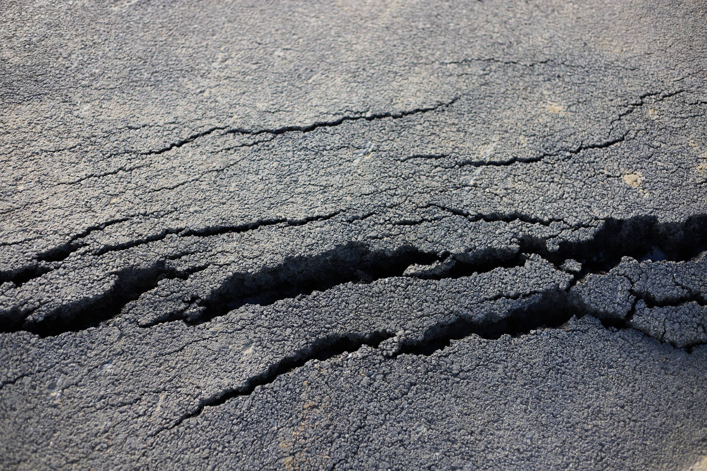 a tarmac driveway with cracks