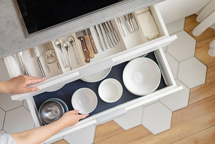 kitchen cabinets with silverware and glassware