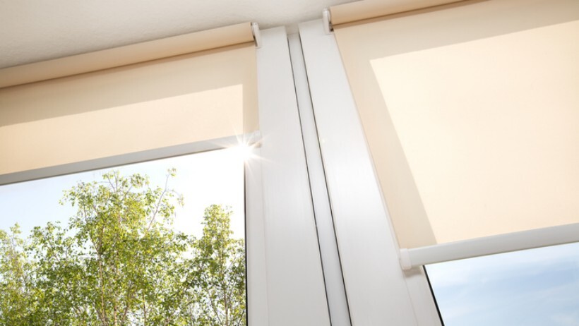 drapes vs curtains vs blinds - window with sand coloured roll blinds