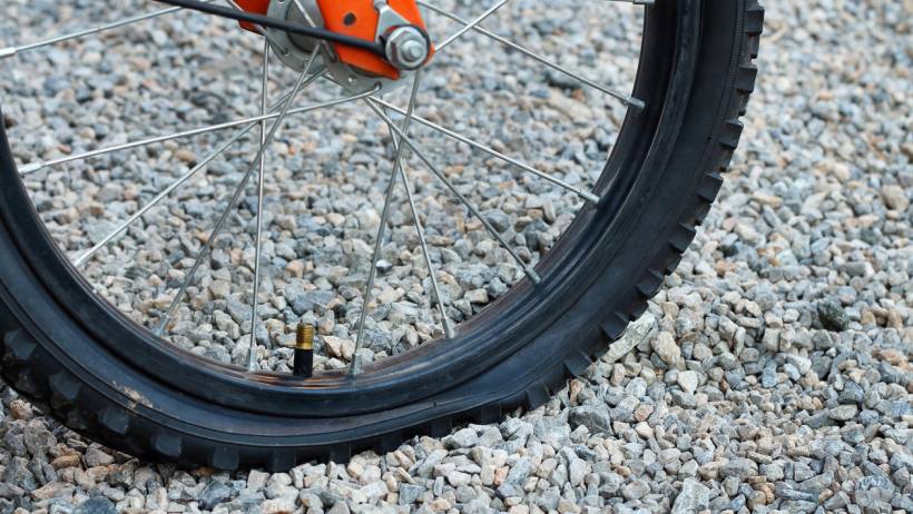 tubeless vs tube: close up of flat tyre bicycle due to a puncture 