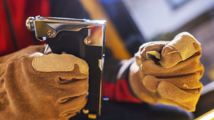 Nail gun vs staple gun - A closeup of a staple gun and heavy duty staples