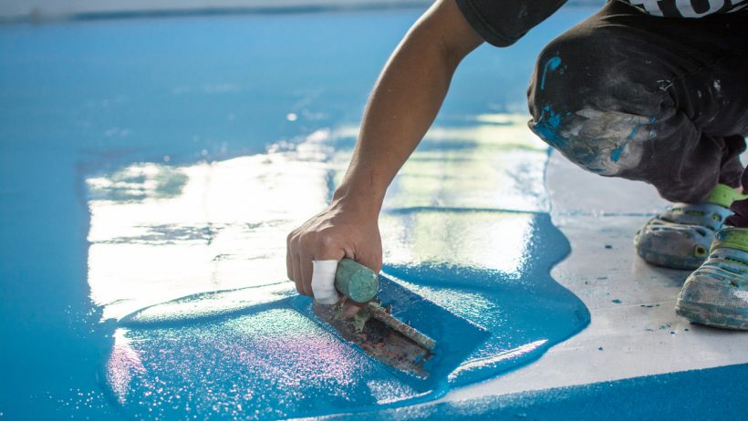 Polyester resin vs epoxy resin - A closeup of a self-levelling blue epoxy floor