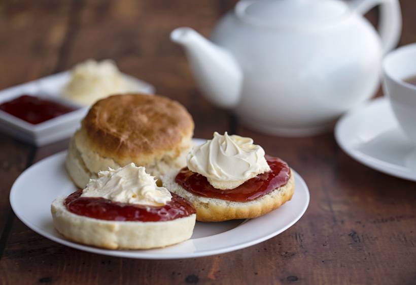 Devon vs Cornwall cream tea - scones with strawberry jam and clotted cream