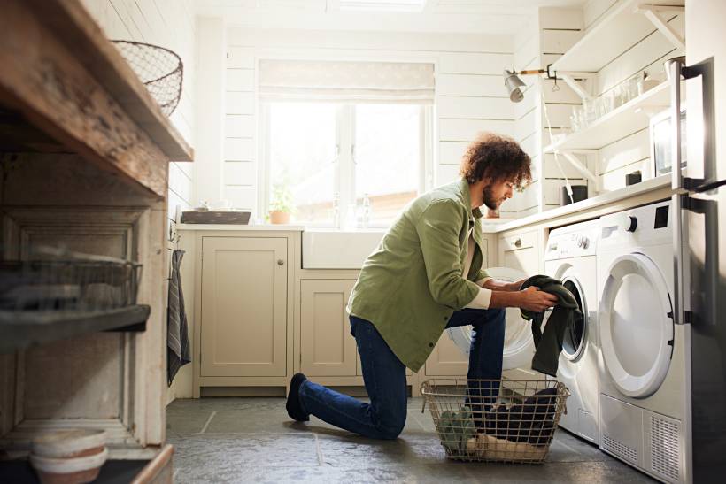 dry cleaning vs washing - a man doing the laundry