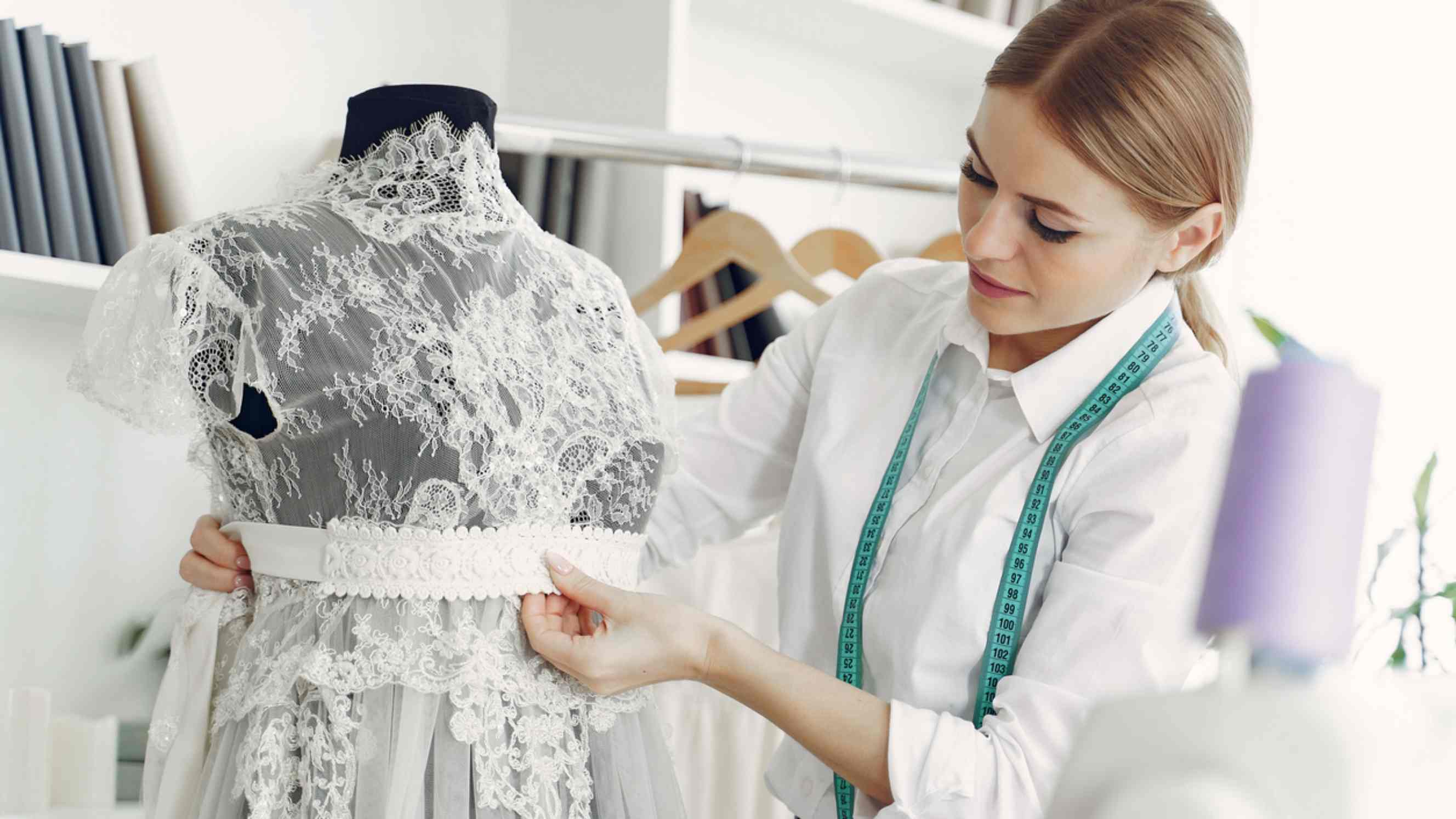 Seamstress vs tailor - A seamstress creating a dress in a studio