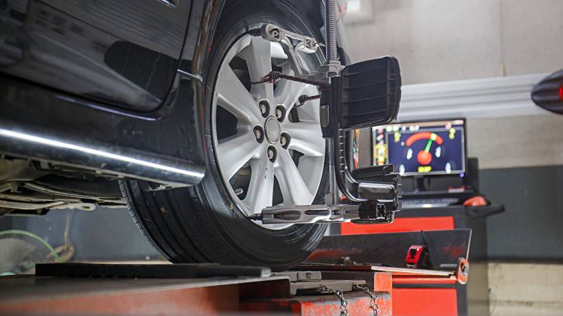 wheel balancing vs alignment - a car on a stand with sensors for wheel alignment