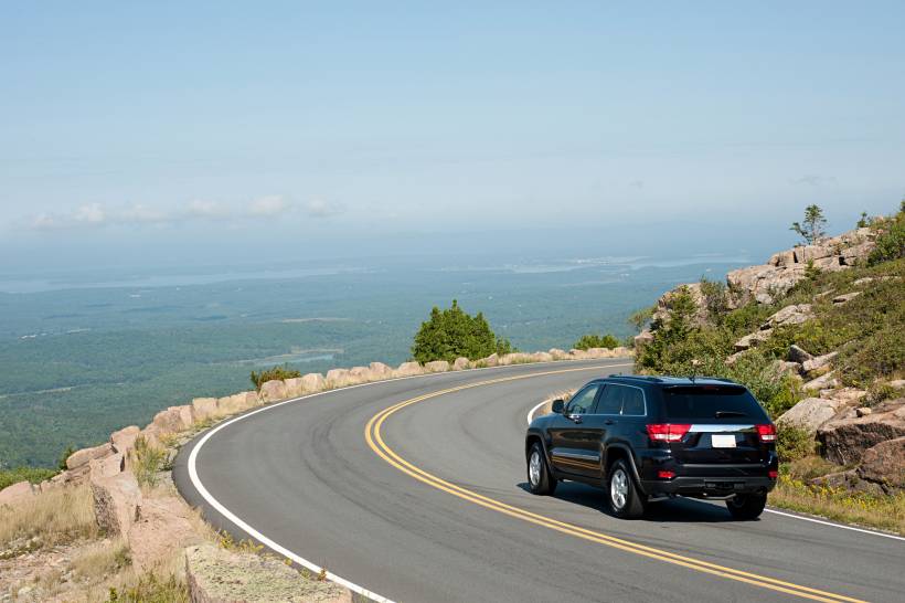 estate vs SUV - a black SUV on a winding mountain road