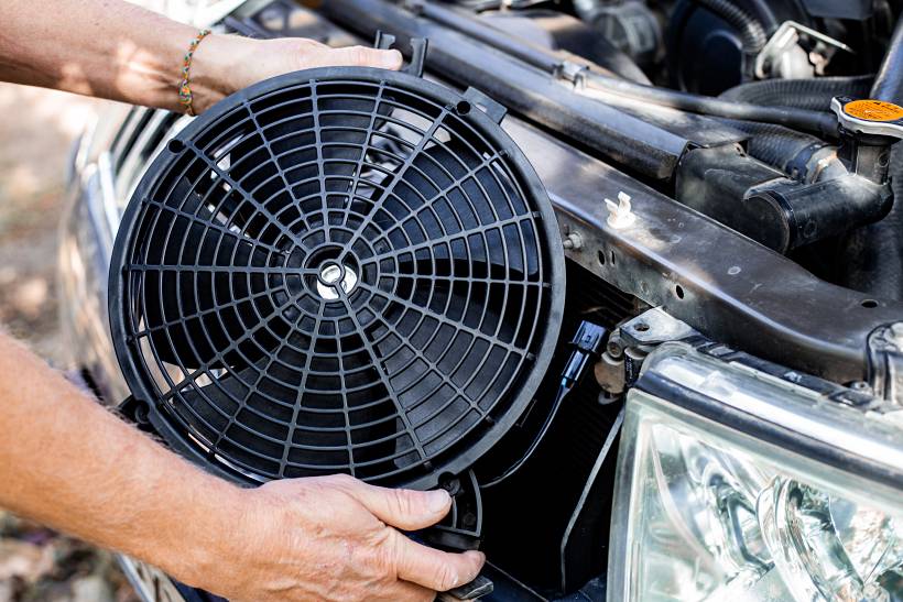 engine replacement cost - a mechanic upgrading a car's cooling system