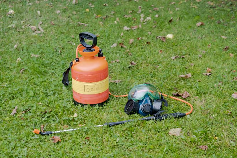 how to dispose of garden waste - an empty tank of pesticide in a garden