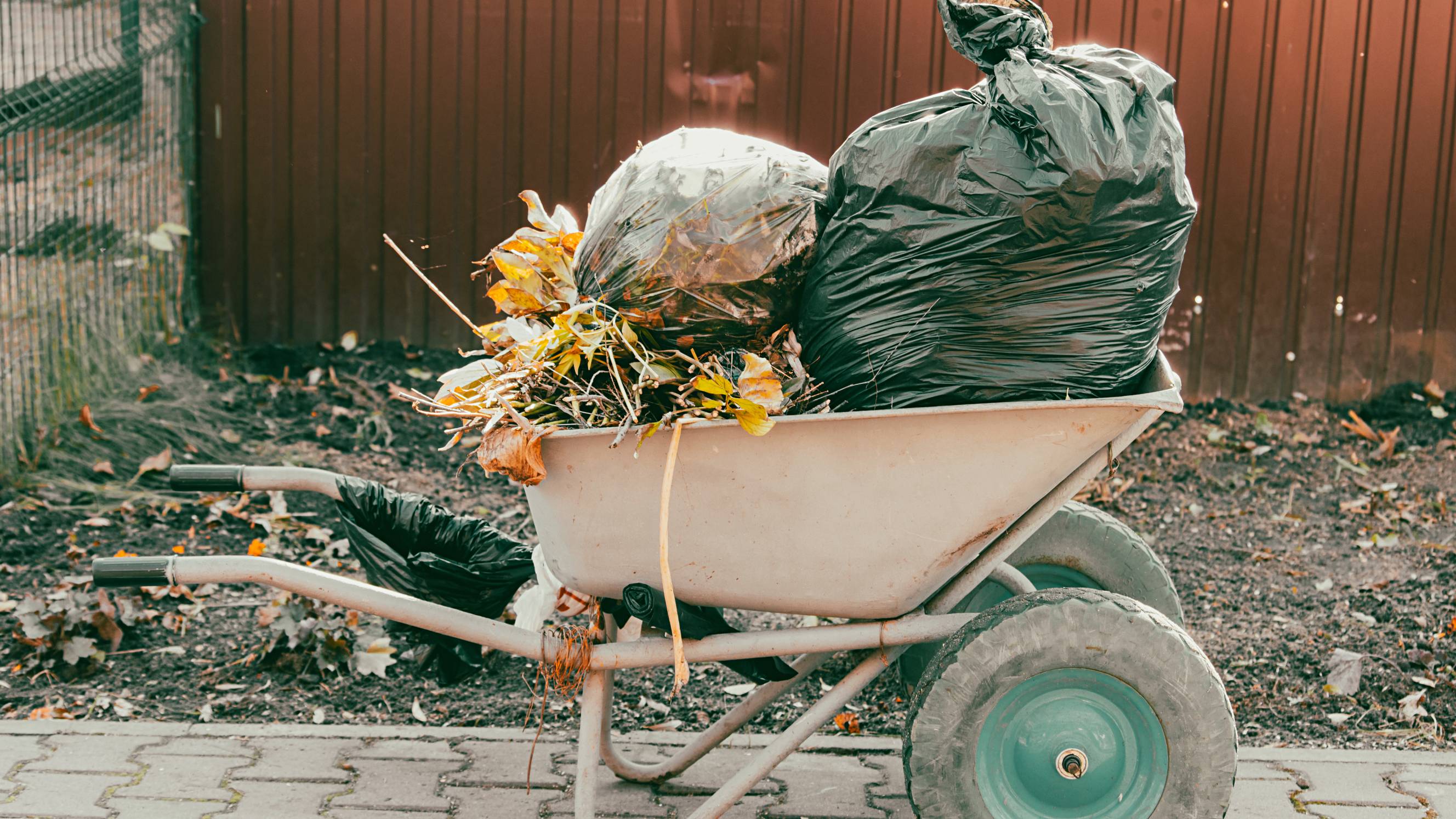 a man carrying a bag full of garbage waste