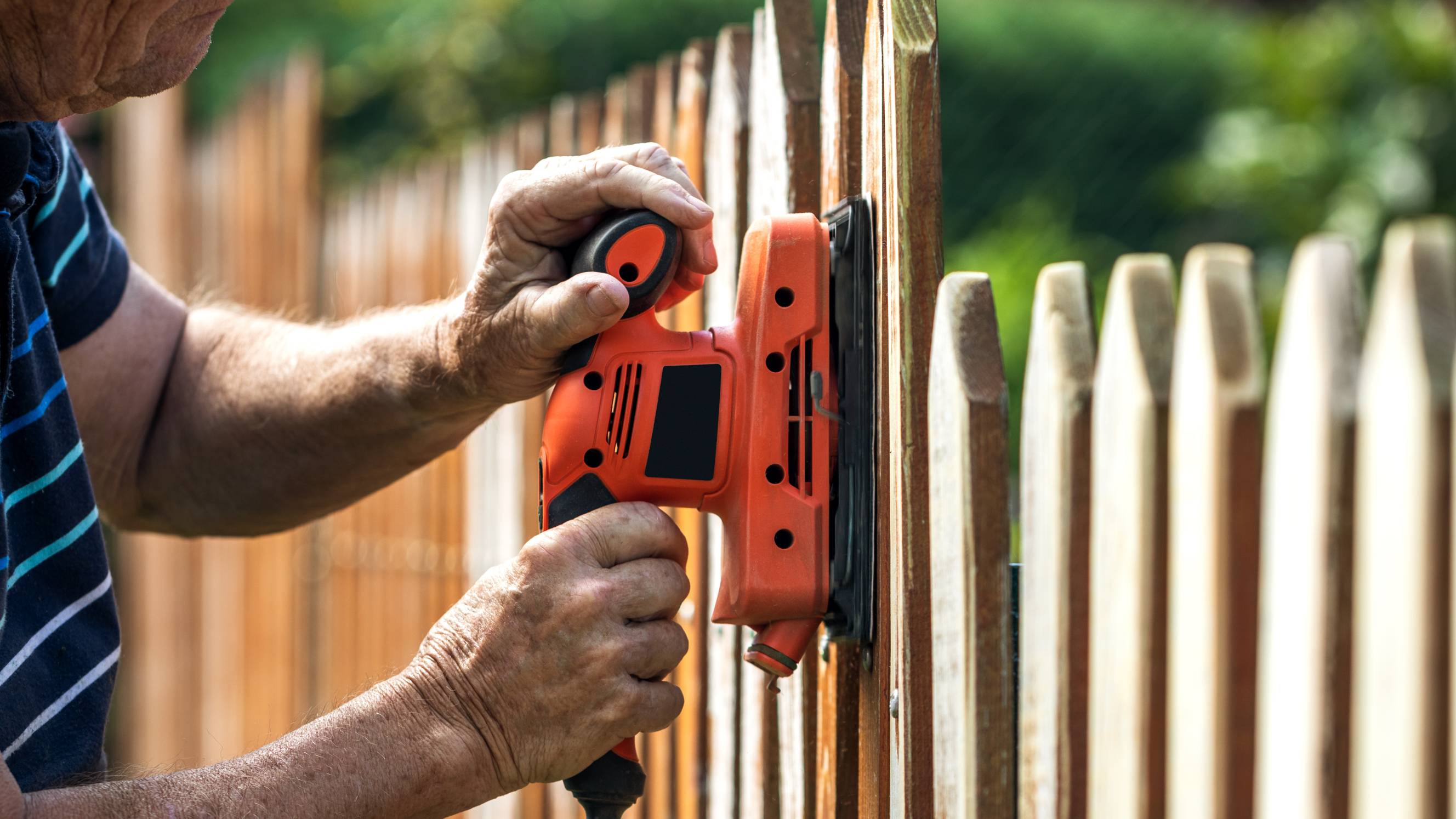 a man installing a metal fence