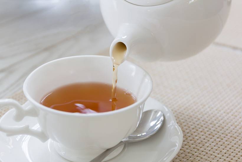 Irish breakfast vs English breakfast - hot tea being poured into a cup