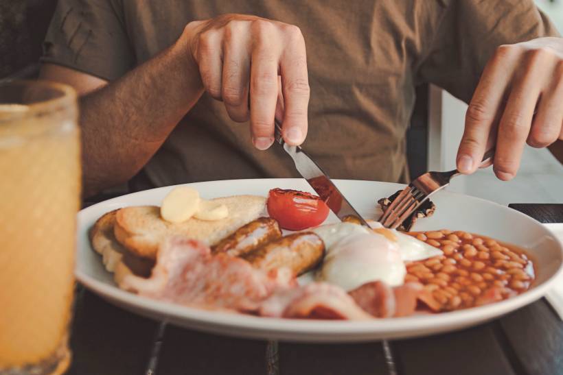 Irish breakfast vs English breakfast - a man enjoying his freshly cooked English breakfast