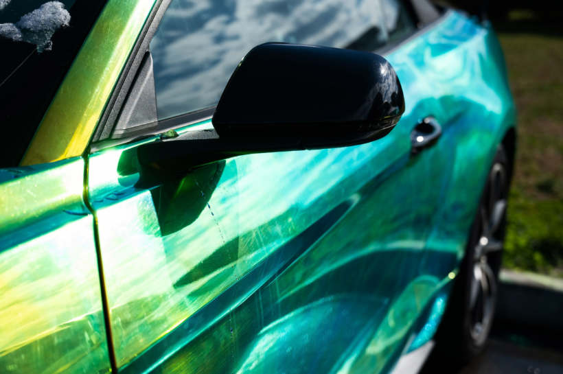 Close-up image of a car with a vibrant, complex wrap design.