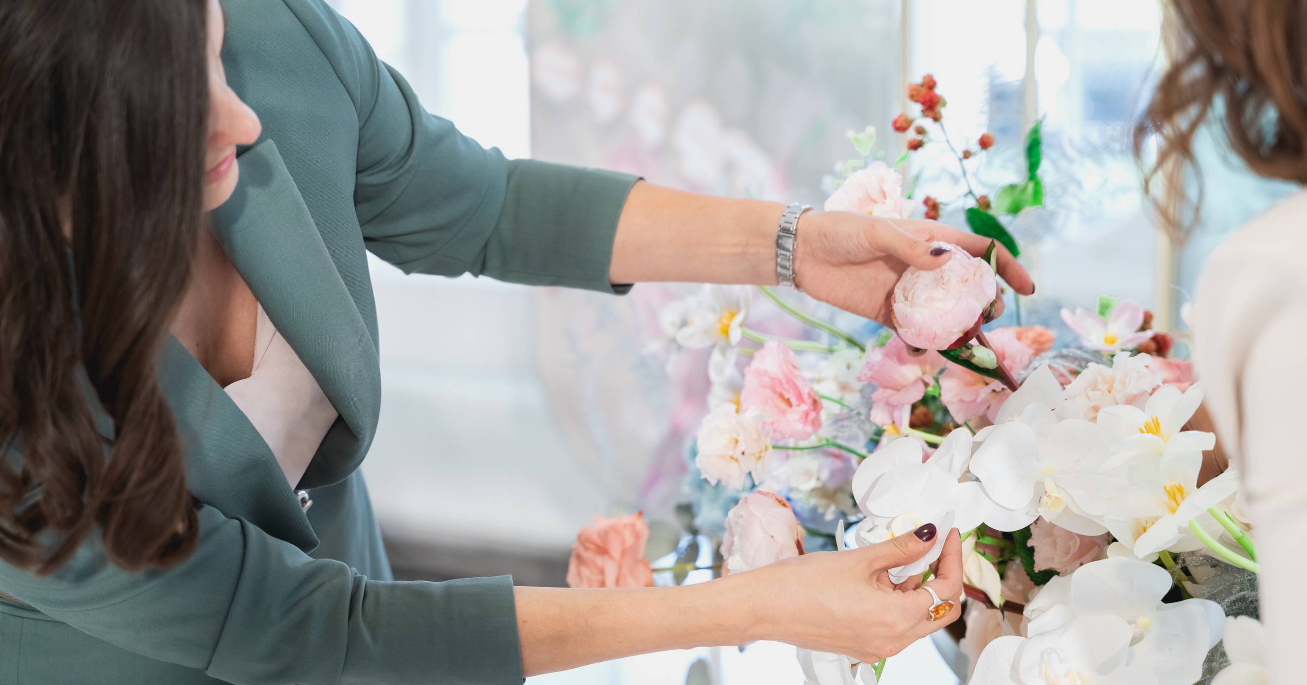 A wedding florist working on a flower composition for the bridal bouquet