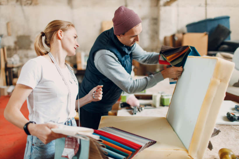 Cost to reupholster a chair - Furniture designers examining fabric options for chair upholstery