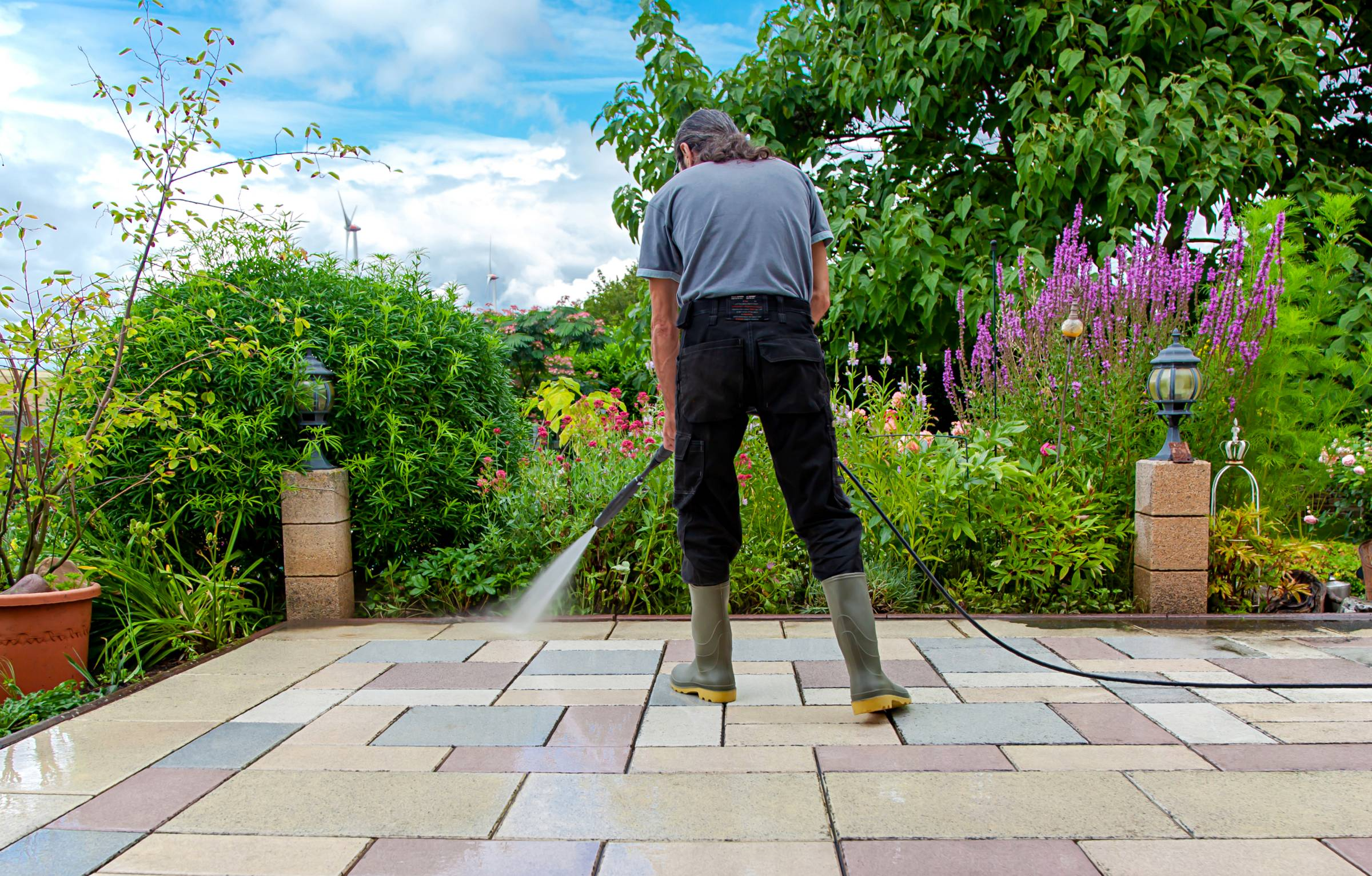 a man cleaning a patio
