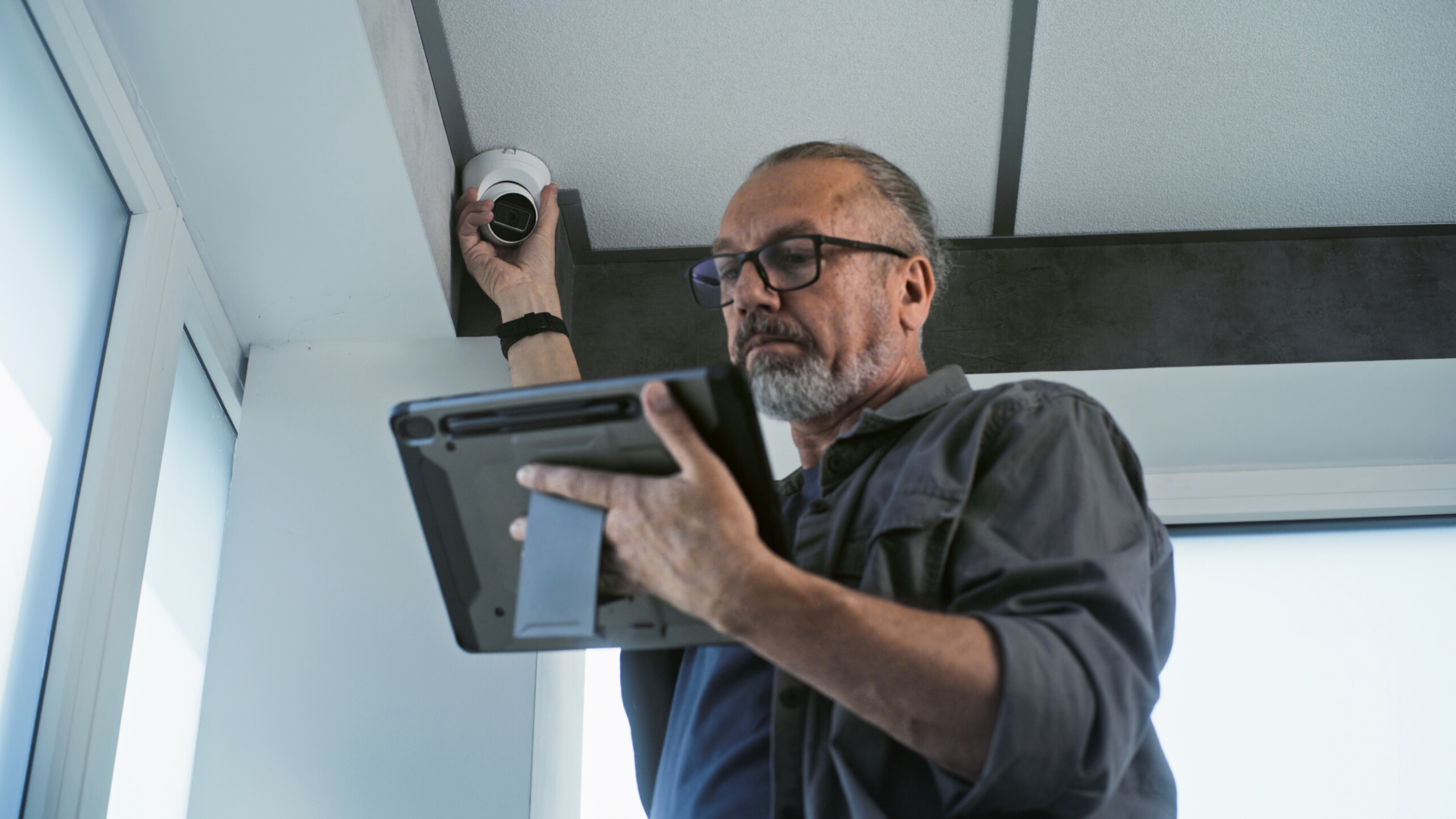 An expert technician testing the feed of a CCTV installation in West Midlands