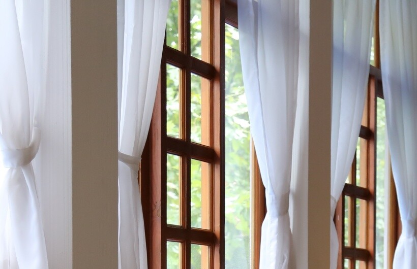Curtain ideas - Tall wooden windows with white sheer door panel curtains tied back