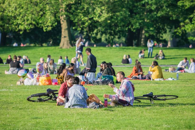 moving to London - People relaxing and having picnics on a sunny day in a London park