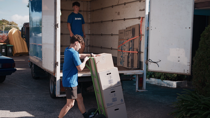 moving to London - Airtasker movers unloading cardboard boxes from a large truck during a house move