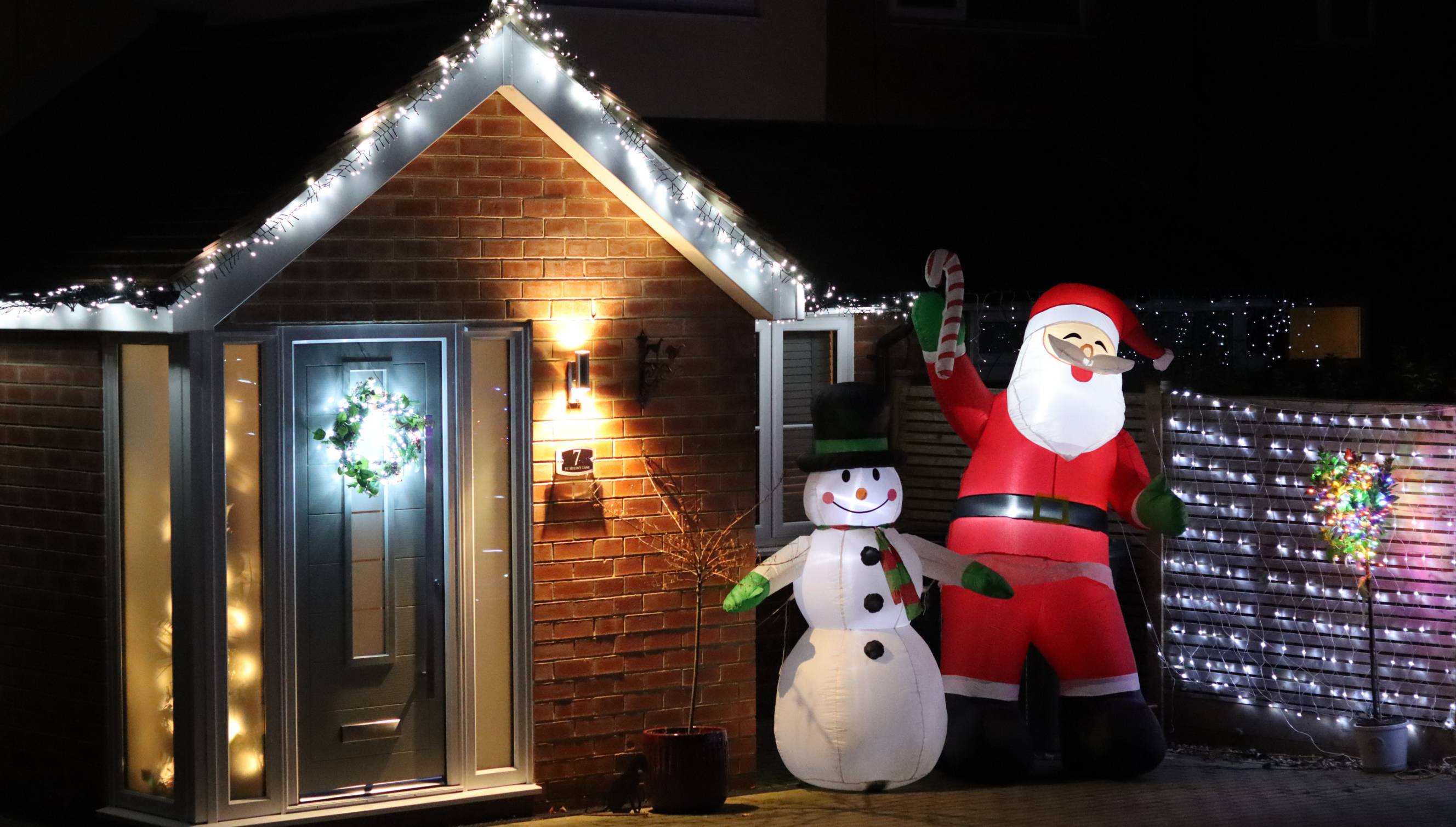 Outdoor holiday lights by Christmas lights installers near you