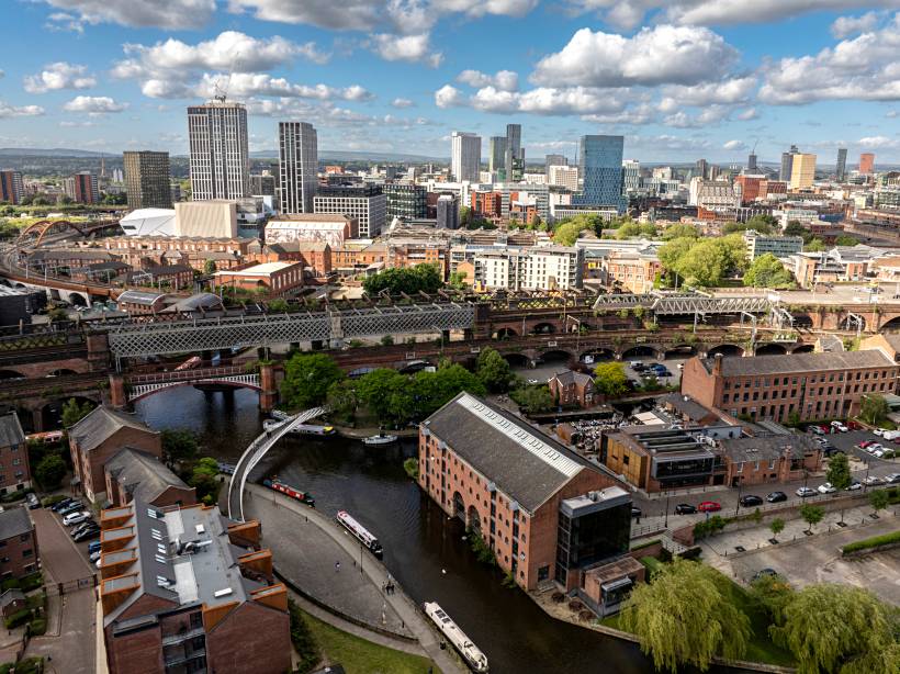 Cityscape showing canals and skyline, depicting what to expect when moving to Manchester