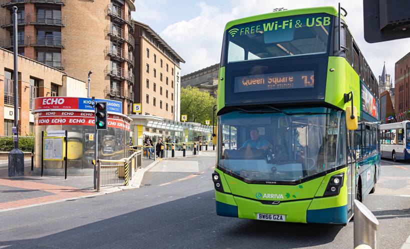 Public transport in Liverpool featuring a green Arriva bus with free Wi-Fi and USB charging