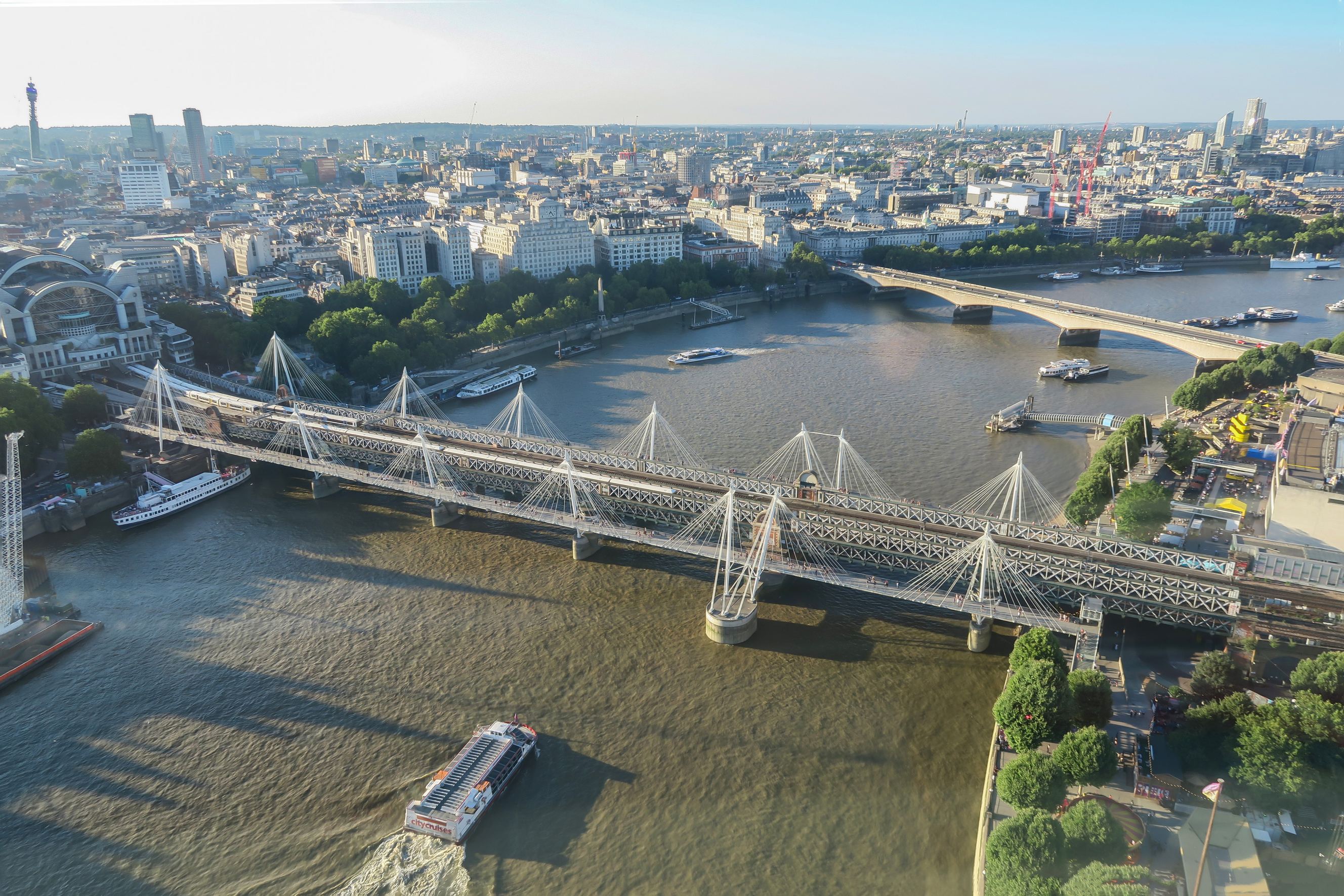 Aerial image of Hungerfors Bridge and Waterloo Bridge over the River Thames with a Ferry sailing across it, skyline of London.