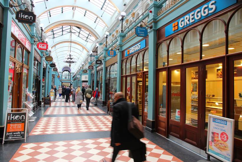 moving to Birmingham - Shoppers inside the historic Great Western Arcade, featuring Greggs and other storefronts