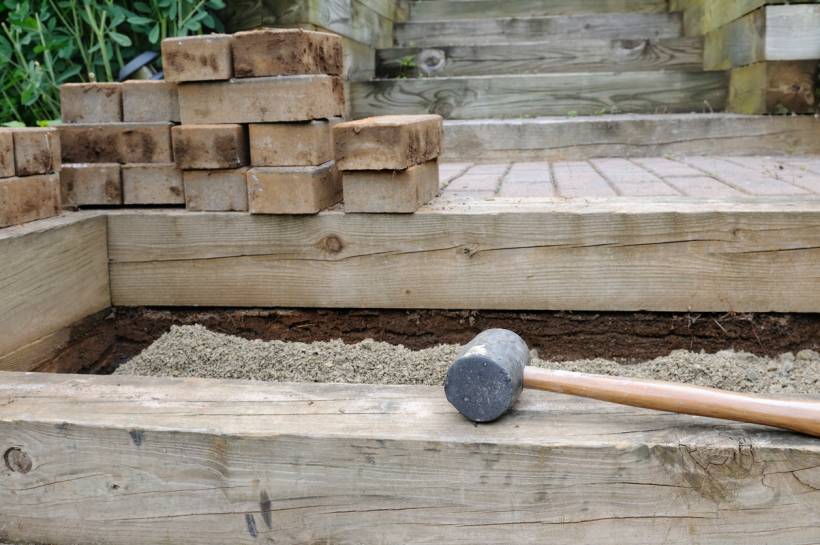 how to build garden steps - Garden step construction materials arranged on a partially built outdoor staircase