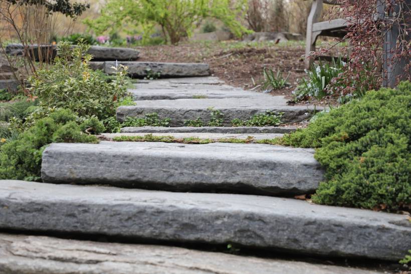 how to build garden steps - Natural stone garden steps creating a gradual path through a landscaped garden