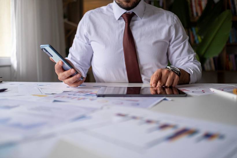bookkeeper vs accountant - Close-up of an accountant reviewing reports and analyzing business performance