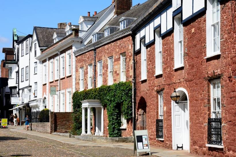 moving to Exeter - Historic red brick houses along Cathedral Close with cobbled street and Georgian architecture