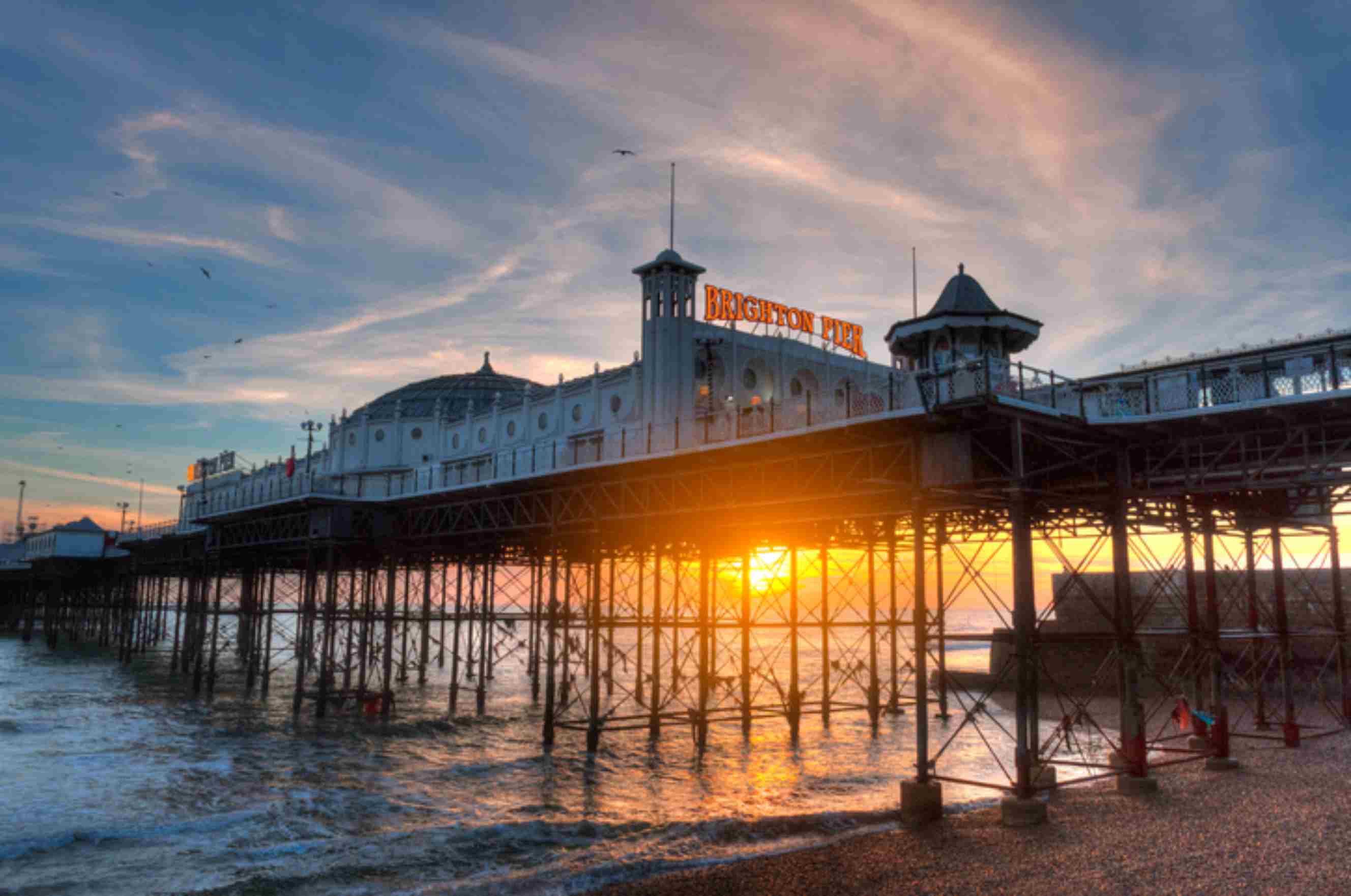 Brighton Palace Pier over the beach at sunset