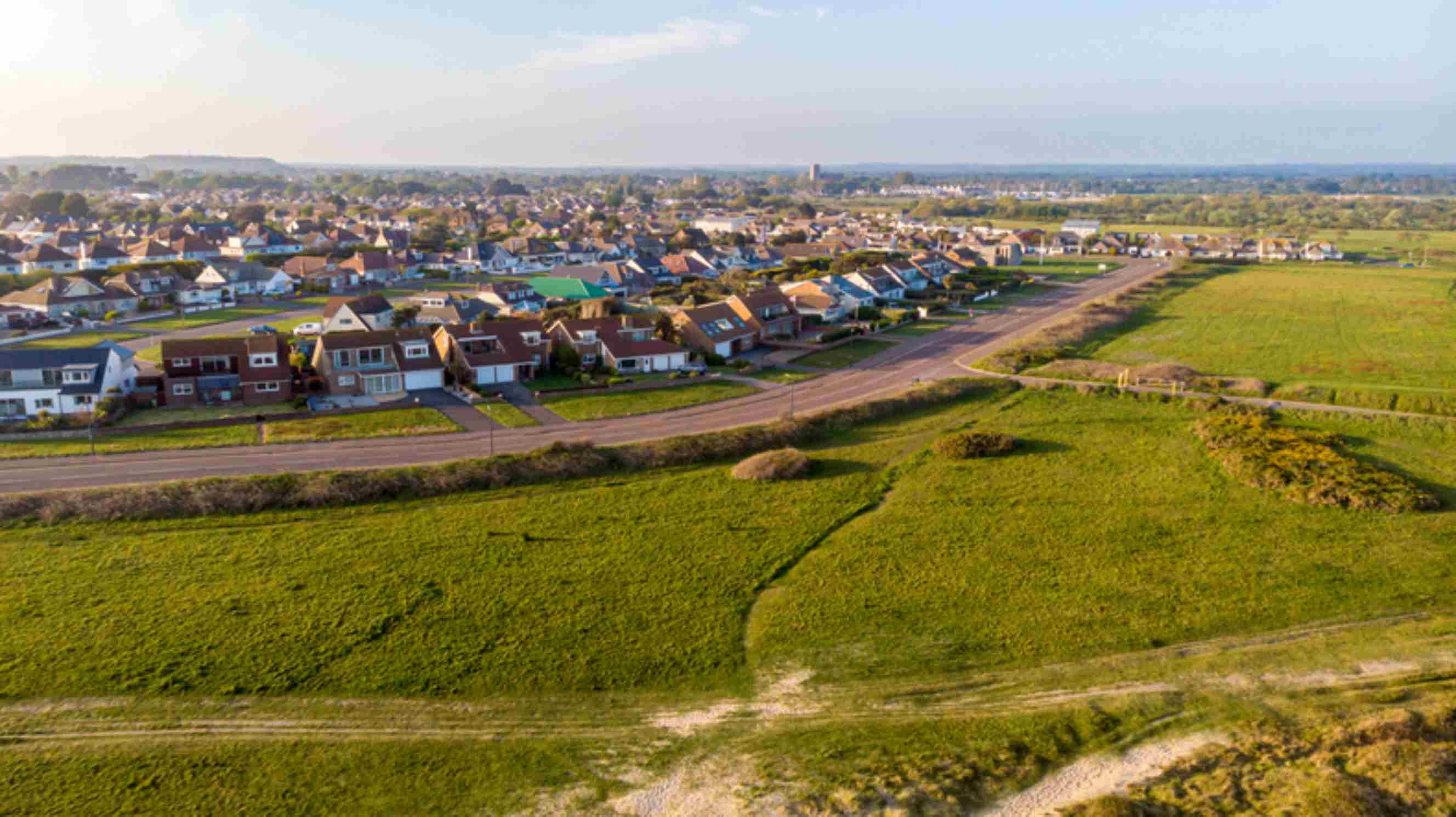Aerial view of homes and green fields