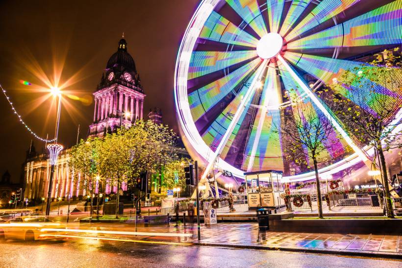 moving to Leeds - Illuminated Ferris wheel beside Leeds Town Hall at night