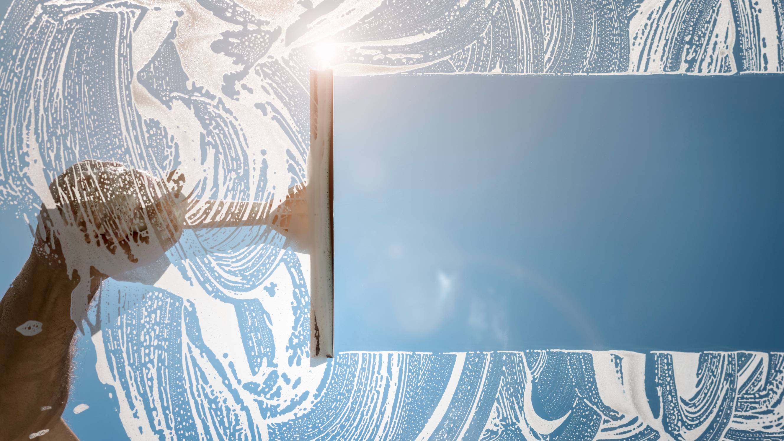 Cleaning glass windows indoors to maintain clarity and hygiene